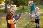 Boys playing with water guns outside