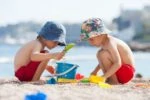 Two cute boys playing in the sand