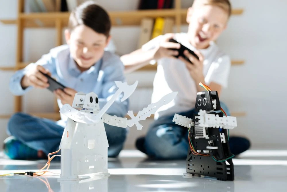 Two young boys battling with robot toys