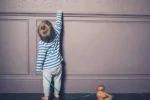 Toddler pulling a toy duck