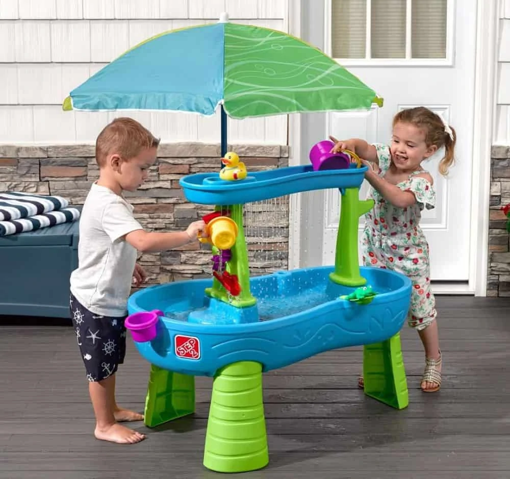Little boy and girl playing with a canopied water table