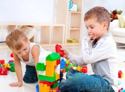 Two little boys playing Legos together
