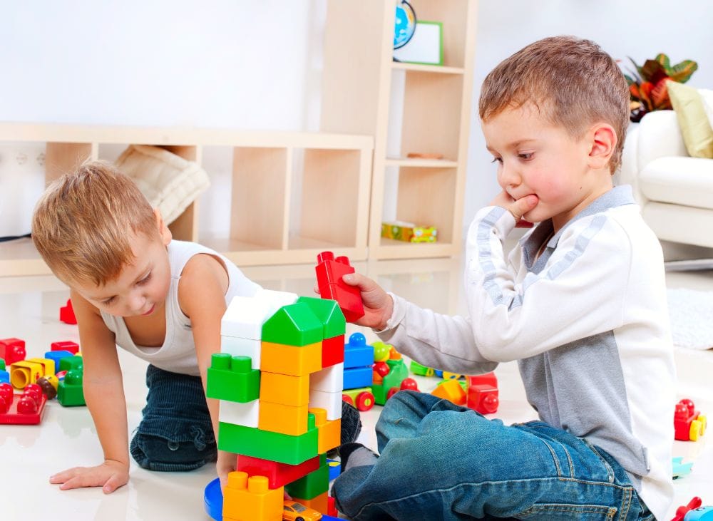Two little boys playing Legos together