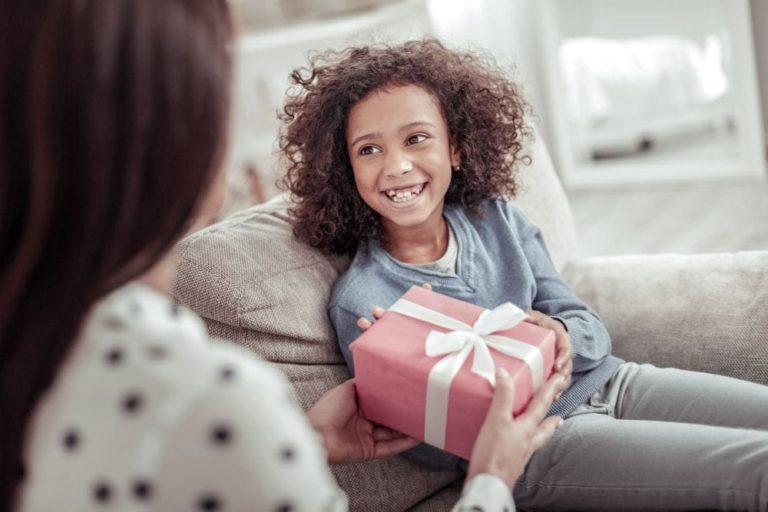 Beautiful African girl receiving a gift with a smile