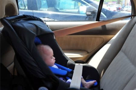 Sleeping infant in a rear facing narrow car seat