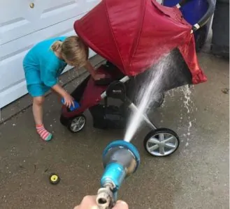 Young kid cleaning a stroller