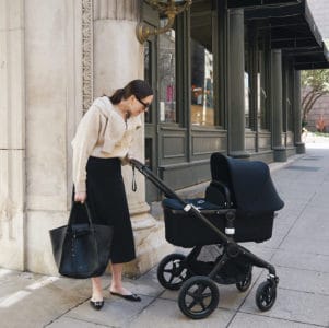 Mother pushing a bugaboo stroller