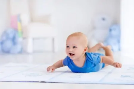 baby boy on a nursery rug