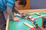 Young boy playing with the best train table