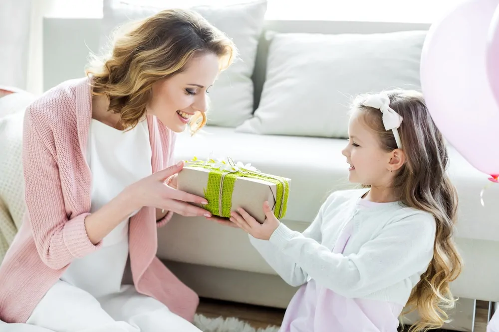 Daughter giving mom a gift