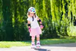 Little girl wearing knee and elbow pads