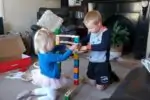 Little boy and girl playing with a marble run toy