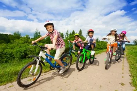 Group of kids riding different bike sizes