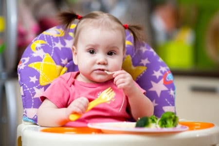 Toddler eating vegetables