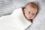 Newborn baby boy wrapped in blanket