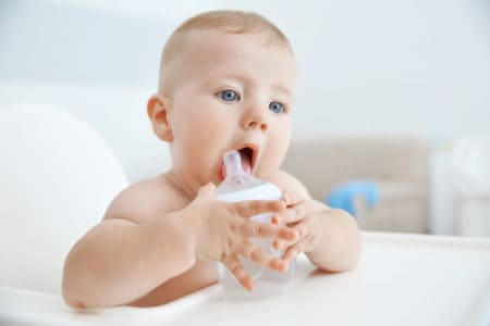 Baby drinking water from a bottle
