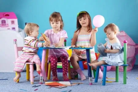 Toddlers and kids coloring at a table