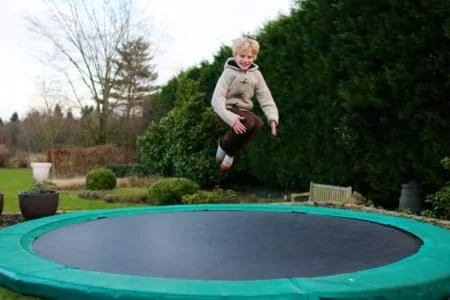 Young boy jumping on a trampoline