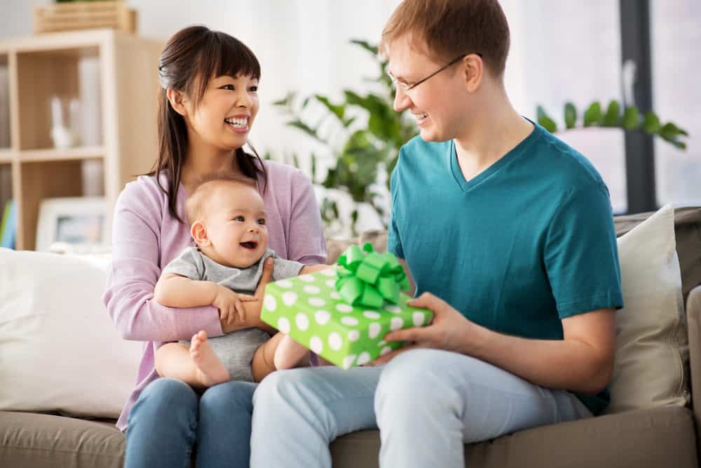 New mom giving husband a gift
