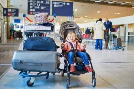 Toddler in a travel stroller at an airport