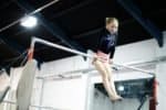 Young gymnast on a gymnastics horizontal bar