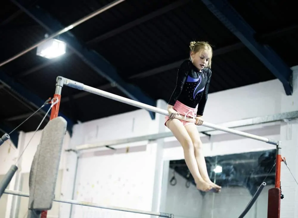 Young gymnast on a gymnastics horizontal bar
