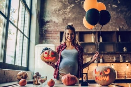 Pregnant woman announcing pregnancy at halloween