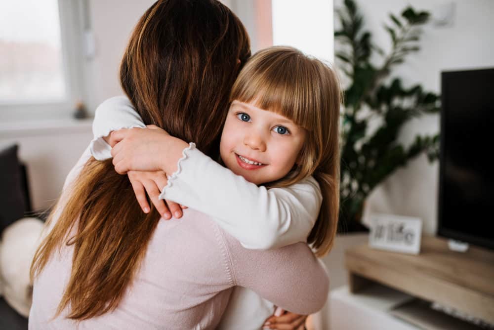 young girl hugging her mother