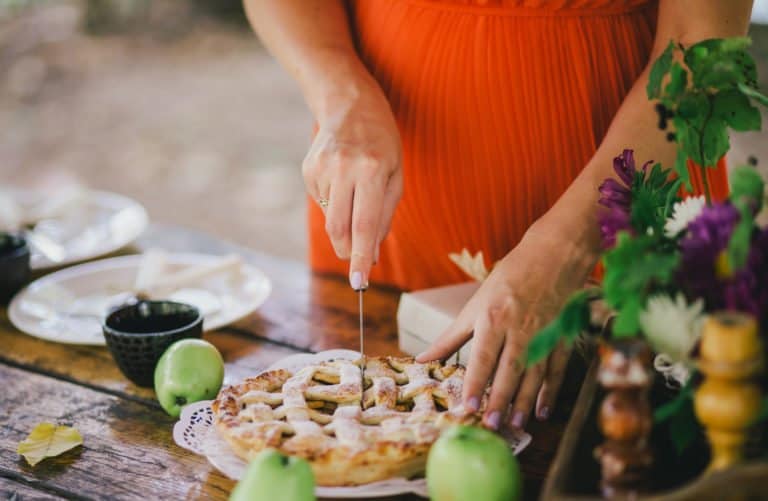 Pregnant woman preparing apple apple for a pregnancy announcement