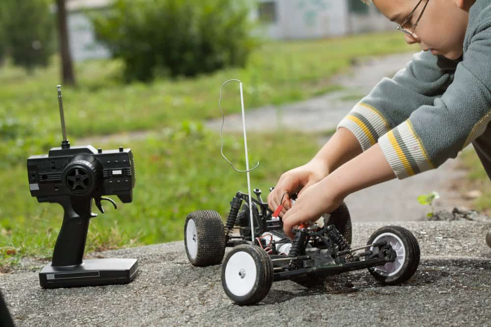 Young boy playing with a remote controlled car