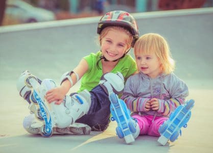 Two little sisters in roller skates