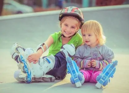 Two little sisters in roller skates