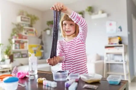 Young girl making stretchy slime