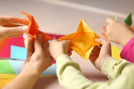 Kids making origami