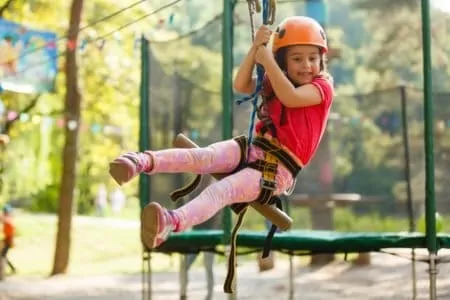 Little girl hanging on zipline