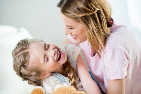 Mother and daughter laughing at a joke