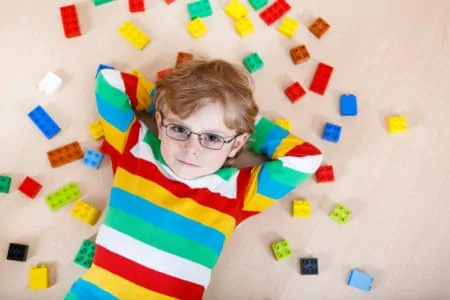Little boy playing with colorful legos