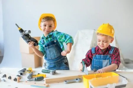 Cute kids playing with construction tool sets