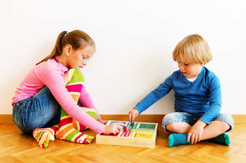 Brother and sister playing a board game