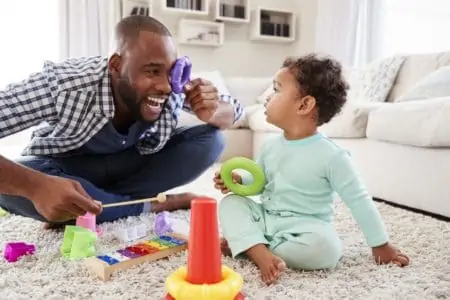 Dad playing toys with 7 month old baby