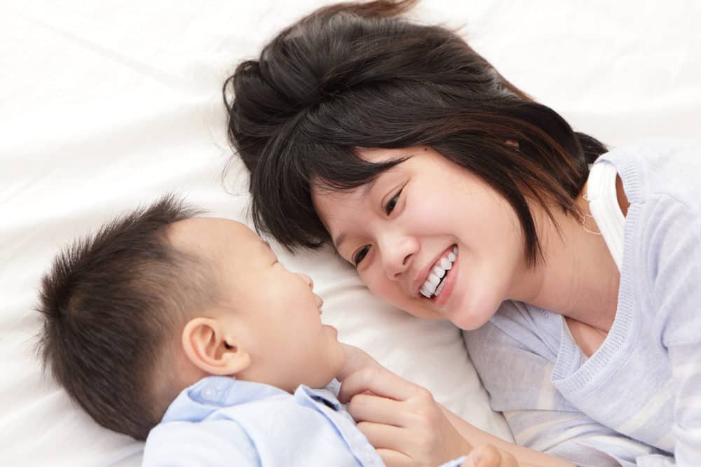 Beautiful Japanese mother smiling at her baby boy