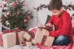 15 year old boy opening his christmas gifts