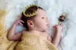 Newborn baby boy with a golden crown