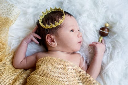 Newborn baby boy with a golden crown