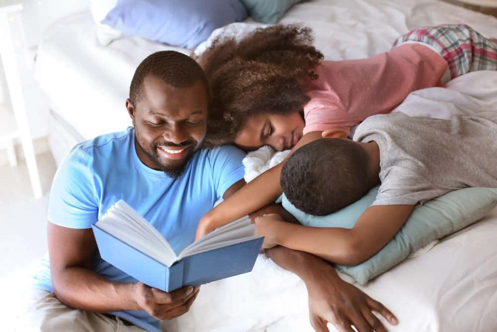 Dad reading a bedtime story to his children