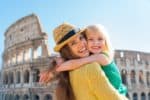 Beautiful mom and daughter in front of the Colosseum in Italy