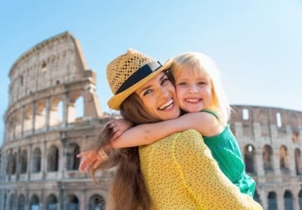 Beautiful mom and daughter in front of the Colosseum in Italy
