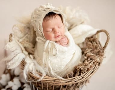 Cute sleeping newborn baby girl knitted bonnet