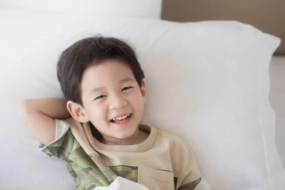 Cute Korean boy lying on the bed
