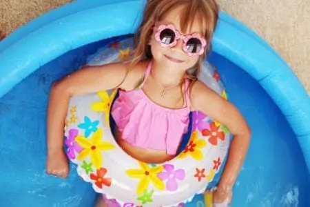 Little girl chilling in a kiddie pool